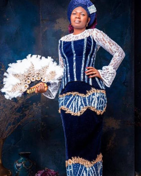 Navy velvet and lace with ndop panels, gold lace trim and a feather fan.